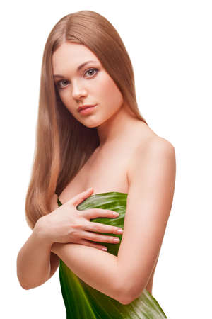 beautiful woman covering with big green leafの写真素材