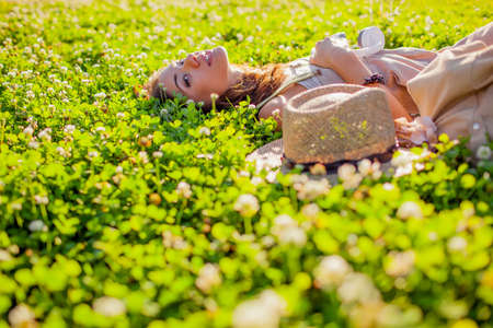 happy beautiful woman lying on grassの写真素材