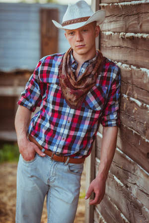 young adult cowboy style man on stableの写真素材