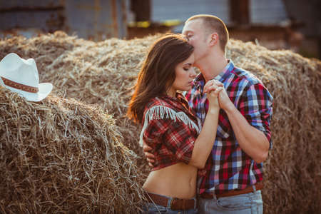 young adult couple embracing near hayの写真素材