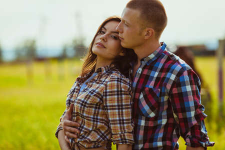 young adult couple couple standing on filedの写真素材