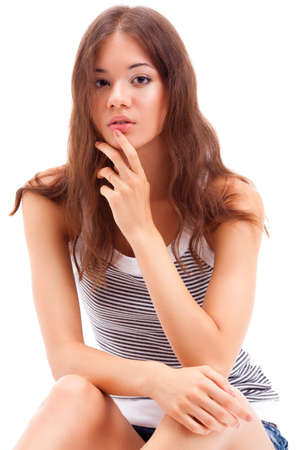 beautiful smiling girl wearing jeans shorts sitting on the floor, closeup portraitの写真素材