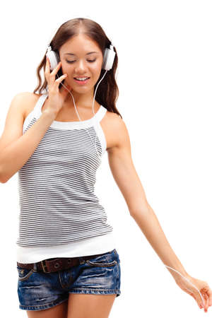 young happy girl wearing headphones over whiteの写真素材
