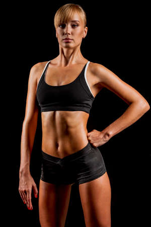 sports woman portrait wearing black sportswear over darkの写真素材