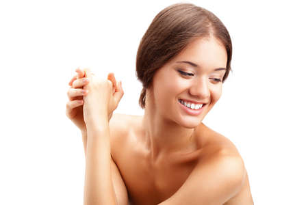 closeup portrait of beautiful smiling  woman with hands and naked shouldresの写真素材