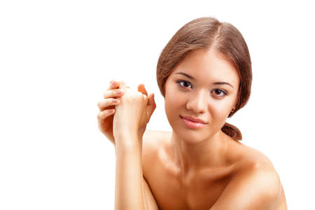 closeup portrait of beautiful smiling  woman with hands and naked shouldresの写真素材