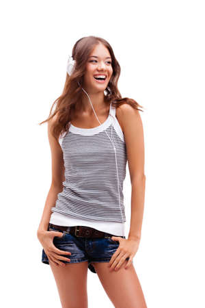 young happy girl wearing headphones over whiteの写真素材