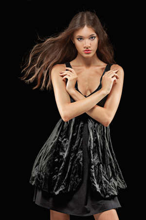 beautiful woman with flying hair fashion portrait  over dark backgroundの写真素材