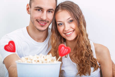 couple with pop corn ad heart symbolsの写真素材
