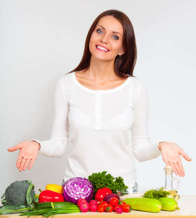 happy smiling young woman with vegetables over white wallの写真素材