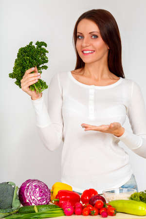 happy smiling young woman with vegetables over white wallの写真素材
