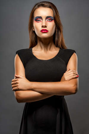 Young sensual and beautiful woman in a fashionable dress with creative makeupの写真素材