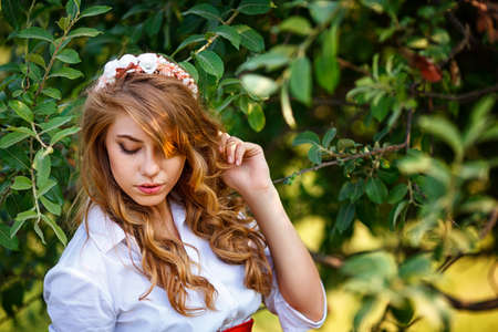 Romantic portrait of the woman standing under the treeの写真素材