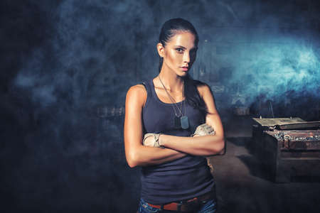 sexy soldier woman on factory ruins, action movie themeの写真素材