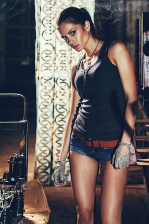 sexy soldier woman on factory ruins, action movie themeの写真素材