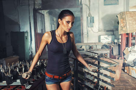 sexy soldier woman on factory ruins, action movie themeの写真素材