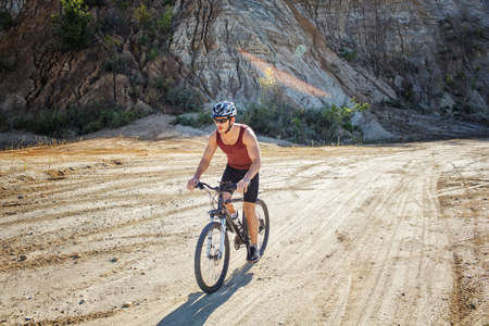 athlete man cycling on a bicycle ounddors in stone pitの写真素材
