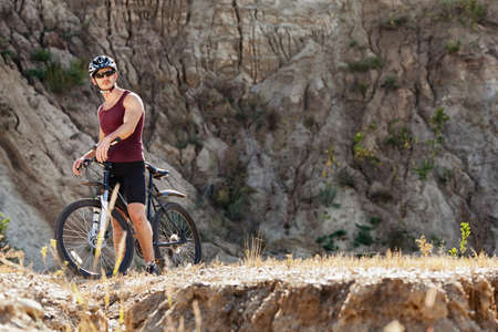 athlete man cycling on a bicycle ounddors in stone pitの写真素材