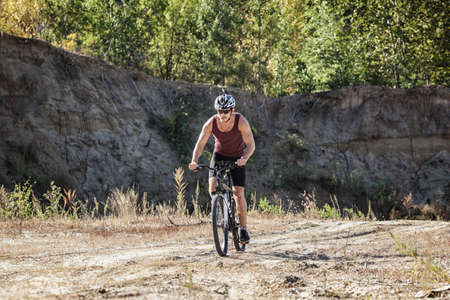 athlete man cycling on a bicycle ounddors in stone pitの写真素材