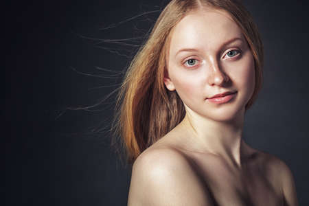 closeup studio portrait of woman with flying hairの写真素材