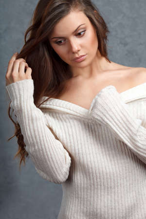 closeup portrait of curly beautiful female model on gray backgroundの写真素材