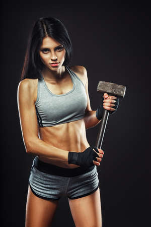 Beautiful brunette woman with a big hammer, crossfit traningの写真素材