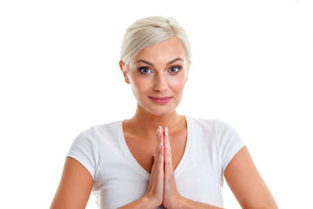 on a white background beautiful blonde woman holding her palms togetherの写真素材