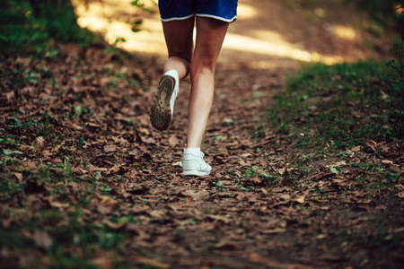 closeup woman runner shoe on park trailの写真素材