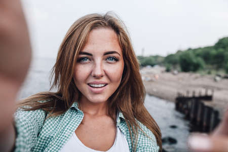 beautiful young adult woman taking picture of herself, selfie.の写真素材