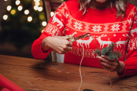 woman hands cutting jute twine, rustic christmas styleの写真素材