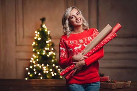 woman holding wrapping kraft paper rolls for gifts, rustic styleの写真素材