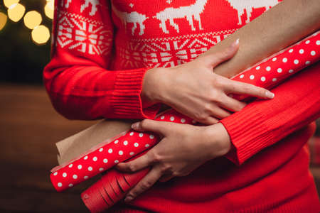 woman holding hands closeup  wrapping kraft paper rolls for gifts, rustic styleの写真素材