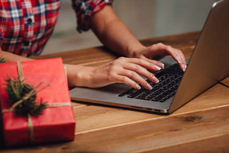 woman hands working with laptop, christmas theme, rustic styleの写真素材