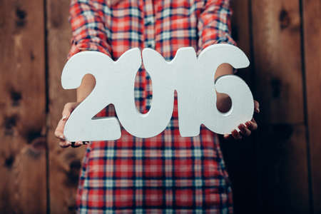 Woman holding in hands New year 2016 numbers, rustic styleの写真素材