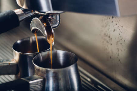 Close-up of espresso pouring from coffee machine, professional coffee brewingの写真素材