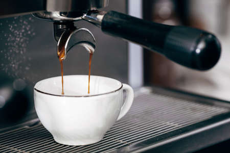 Close-up of espresso pouring from coffee machine, professional coffee brewingの写真素材