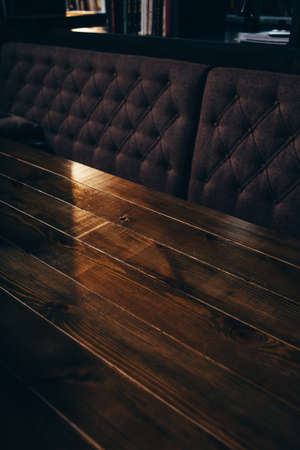 part of cafe interior in the early morning, wooden table and sofa