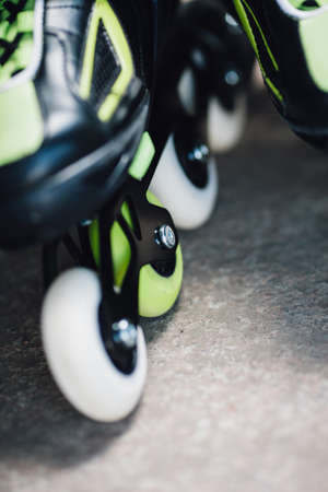 green and white wheels of roller skates closeupの写真素材