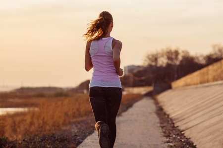 Female fitness woman training outside on a sunset. Sport lifestyle.