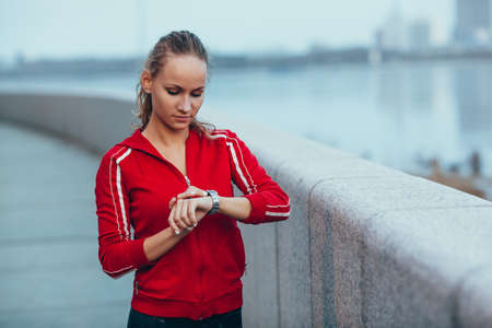 Woman setting up the fitness smart watch for running outdoorsの写真素材