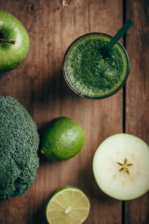 Overhead view of fresh green smoothie from fruit and vegetables, healthy eating, selective focus. Apple. lime, broccoliの写真素材