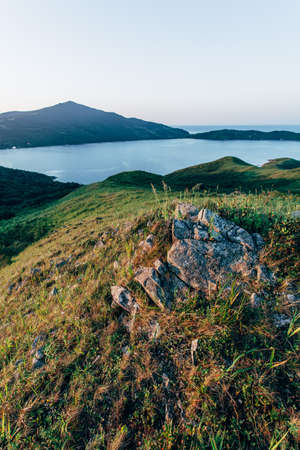 eraly sunrise over hills and sea bay, view from high pontの写真素材