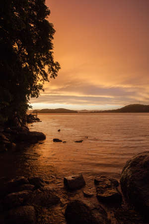dramatic sunset skies in the sea bay, rainy eveningの写真素材