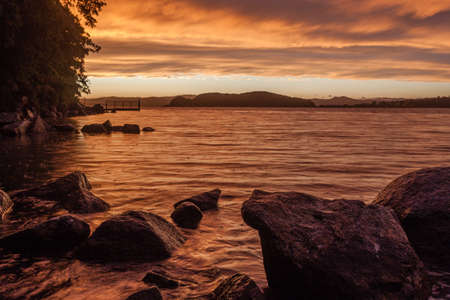 dramatic sunset skies in the sea bay, rainy eveningの写真素材