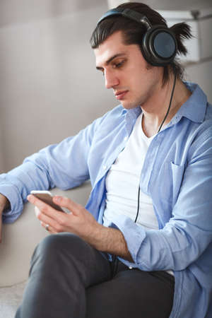 Handsome guy listening to music on internet with smartphoneの写真素材