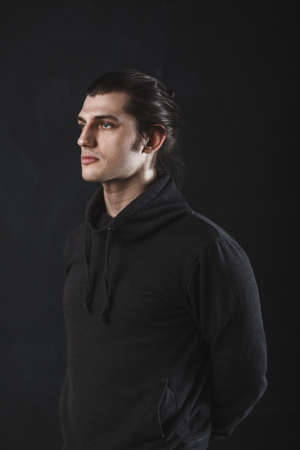 handsome guy on dark background in studioの写真素材