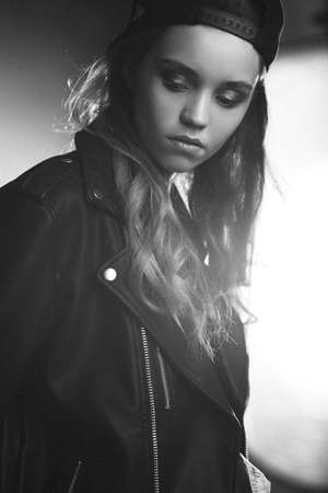 young teenage girl closeup black and white portrait over shiny backgroundの写真素材