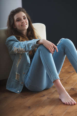 young teenage girl wearing jeans jacketの写真素材