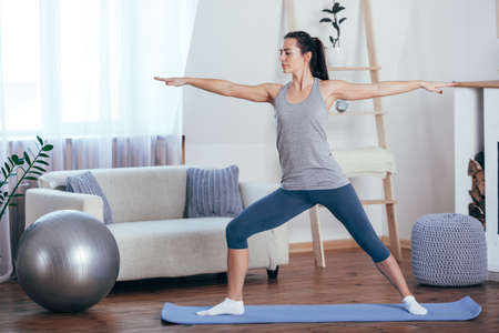 Young cheerful attractive woman practicing yogaの写真素材