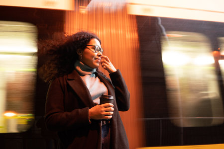 Young holding coffee before leaving tramway